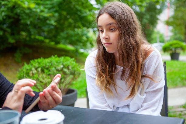 istock Mother with daughter in a sidewalk cafe 1035491240