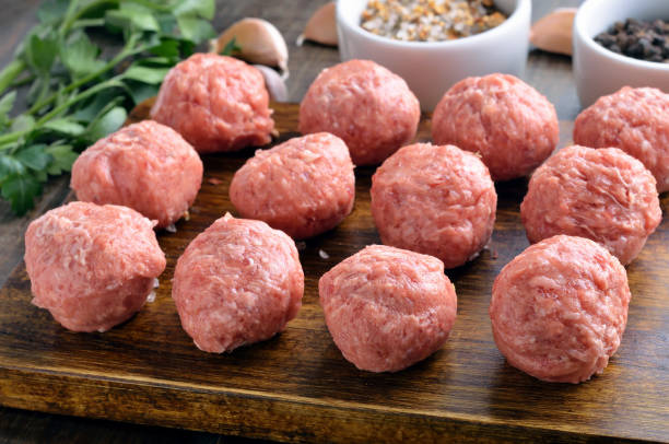 istock Raw meatballs on a cutting board 1035492154