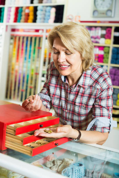 istock mature woman customer in sewing store 1035493020