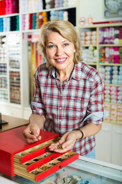 istock mature woman customer in sewing store 1035493028