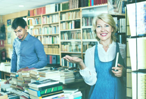 istock Mature smiling woman picking new book 1035495862