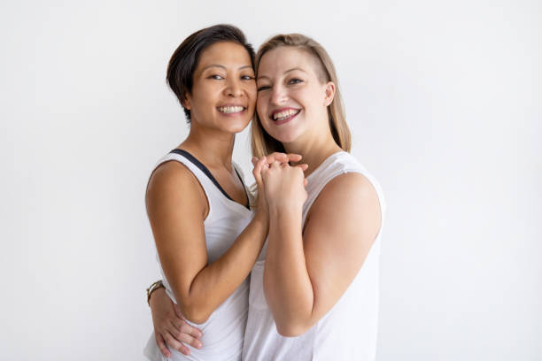 istock Happy lesbian couple embracing and looking at camera 1035496518
