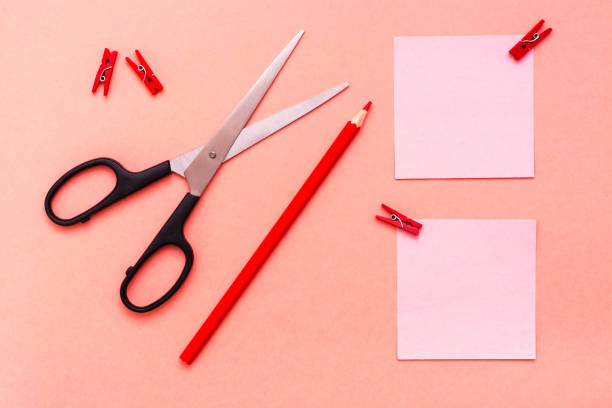 istock Stationery - sheets for notes clipped, pencil and scissors on a red background 1035505194