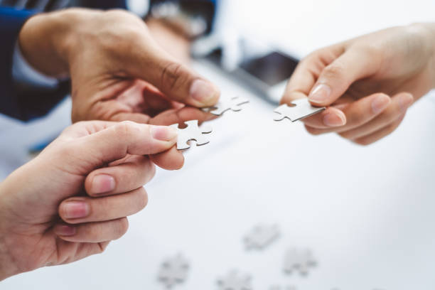 Hand business man holding jigsaw puzzle for connection teamwork together concept