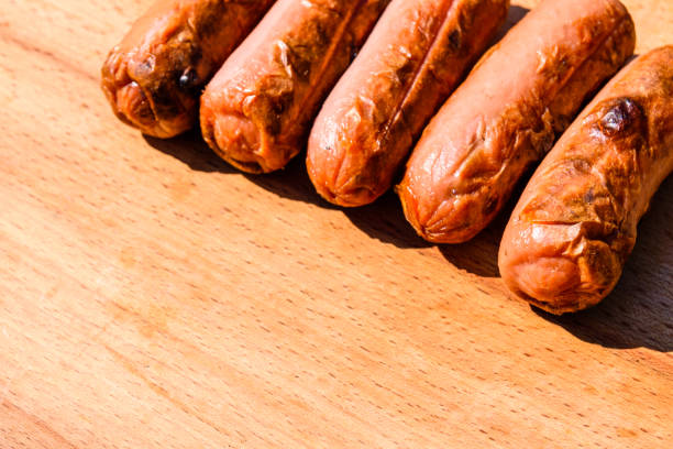 istock Roasted sausages on the rustic wooden table. Top view 1035508806