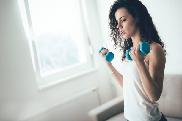 istock Young attractive sportswoman doing exercises at home 1035511930