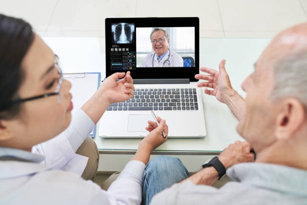 istock Doctor and patient watching laptop 1035512730