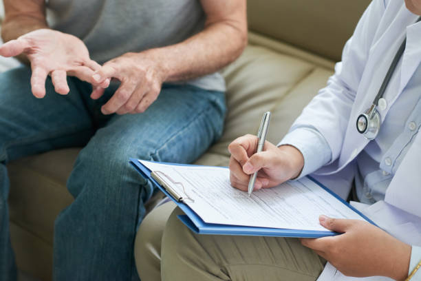 istock Crop doctor writing patient complaints 1035512746