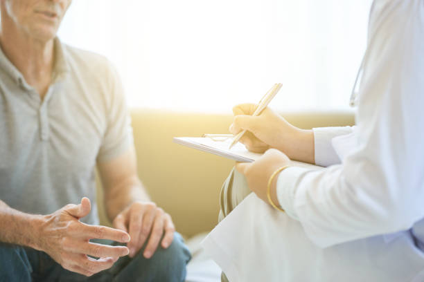 istock Crop patient and doctor with clipboard 1035512750