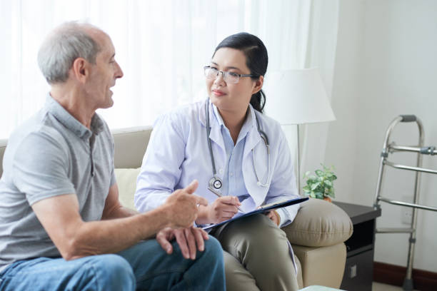 istock Doctor talking to senior client at home 1035512758