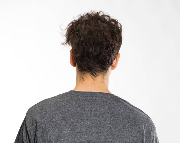 istock Young man with curly hair back portrait 1035513024
