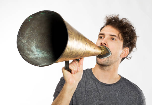 istock Young man yelling into a retro megaphone 1035513140