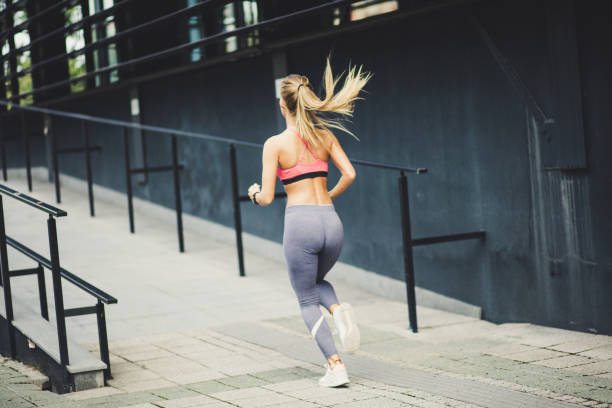 istock Young beautiful blonde women running.   From back. 1035513210