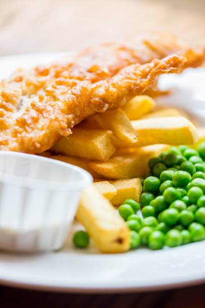 London UK, September 03 2025,  Breaded Cod Fillet With Sliced New Potatoes And Mushy Peas With No People