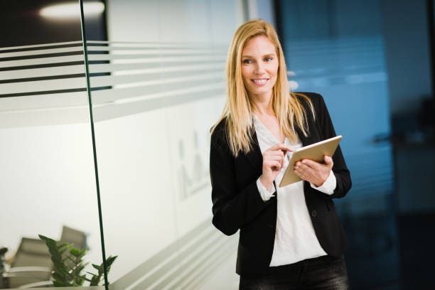 istock Attractive businesswoman using digital tablet in office 1035513946