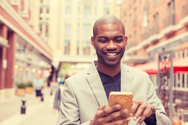 istock Happy smiling urban professional man using smart phone. 1035517810