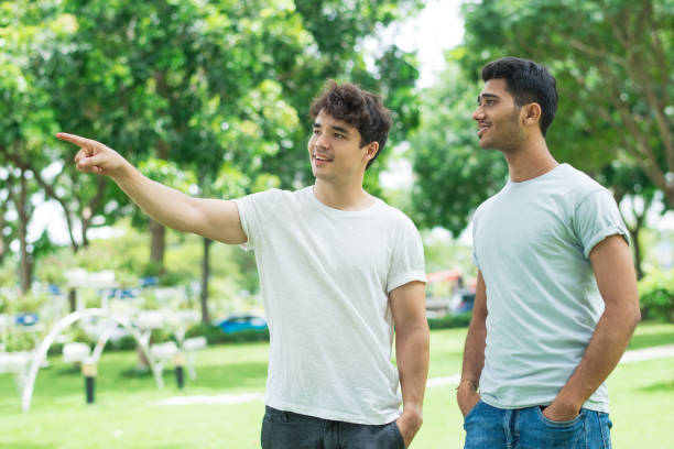istock Positive friendly guy showing direction to Indian man 1035518464
