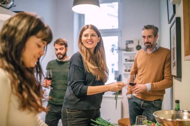 istock friends cooking and socializing in kitchen during party 1035519038