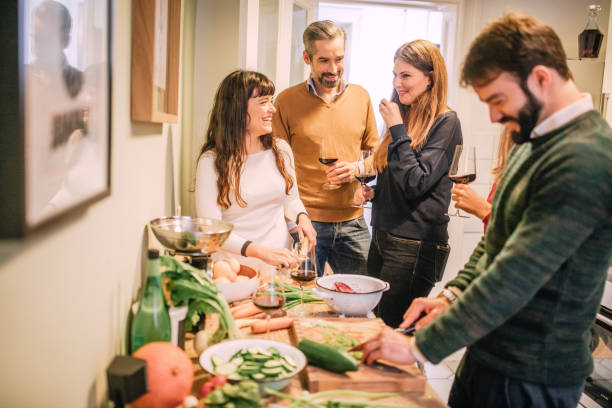 istock friends cooking and socializing in kitchen during party 1035519462