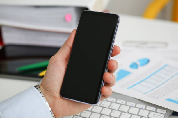 istock A businessman holds a new smartphone in 1035519792