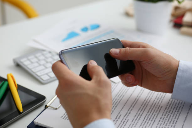 istock A businessman holds a new smartphone in 1035519804