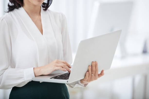 istock Crop businesswoman using laptop 1035522034