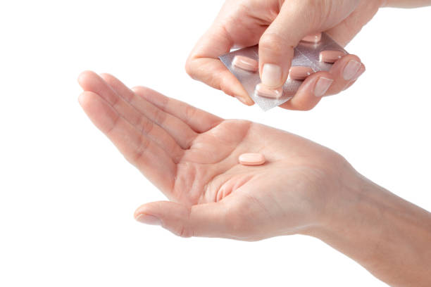istock pills in woman hand 1035523538