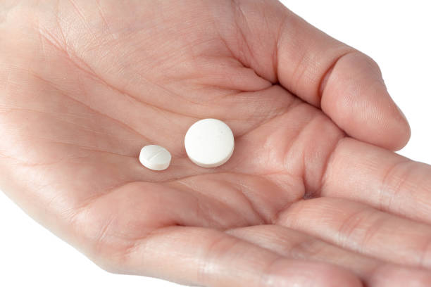 istock pills in woman hand 1035523600