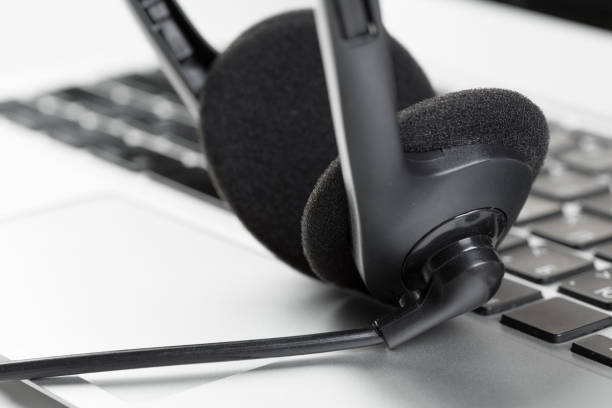 istock call center support concept. headset on keyboard computer laptop 1035523750