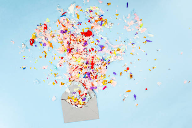 istock Envelope with party confetti explosion on pastel blue background. 1035524020