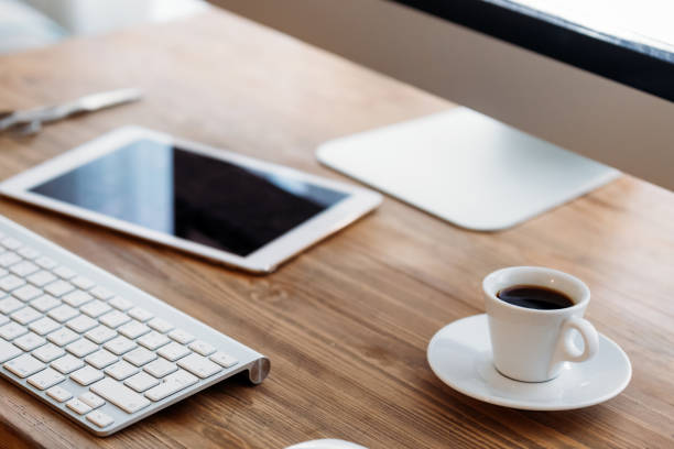 istock Office desk with computer, tablet and cup of coffee 1035526778
