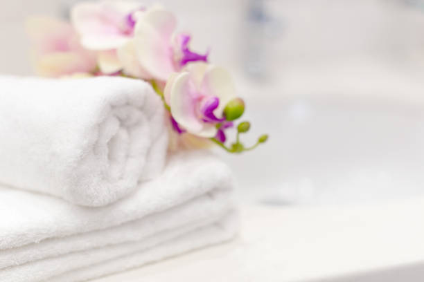 Stack of towels with flower decor in a hotel room