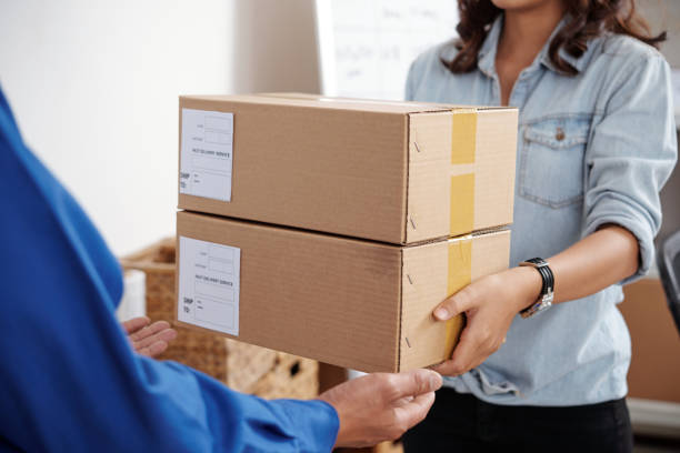 istock Postwoman delivering package 1035530002