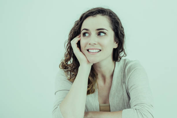 istock Smiling Attractive Woman at Table Looking Away 1035530846
