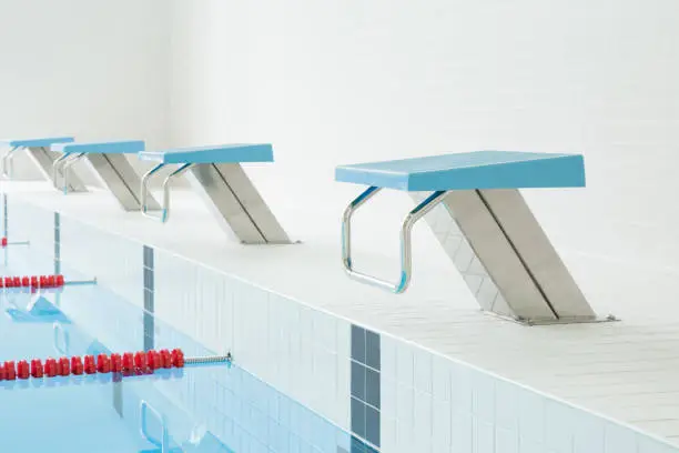 Swimming pool with starting blocks. Sport facility. Side view.