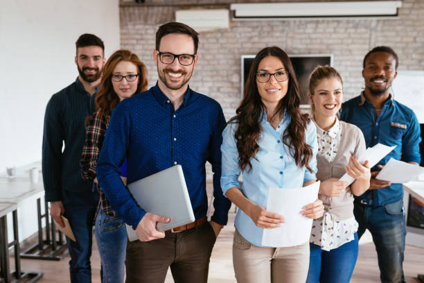 istock Group of successful young architects posing in office 1035534630