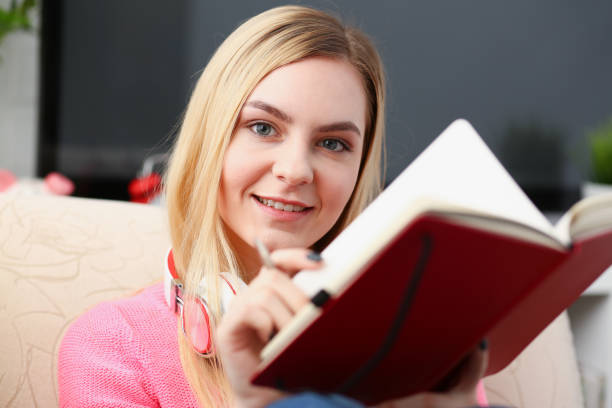 istock young beautiful woman fill in your personal diary 1035534784