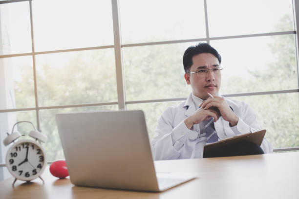 istock Doctor is working at a desk with laptops and tablets in the office. 1035535998
