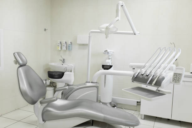 istock A modern, well-equipped dentist's workplace, a patient's gray chair. Machine for drilling teeth and other dental equipment 1035536002