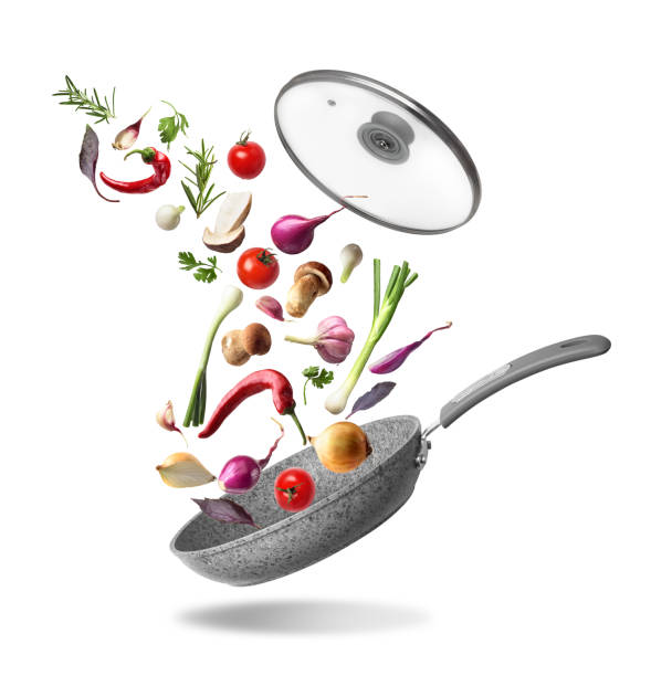 istock Vegetable composition. Frying pan with lid and flying vegetables, isolated on white background 1035536380