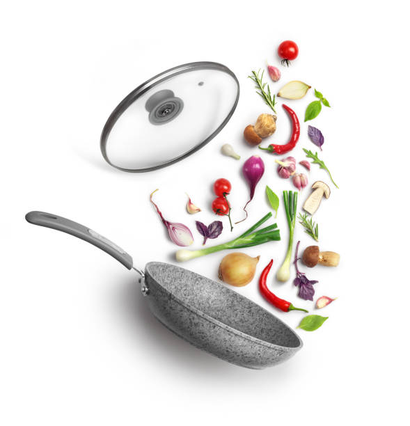 istock Vegetable composition. Frying pan with lid and flying vegetables, isolated on white background 1035536450
