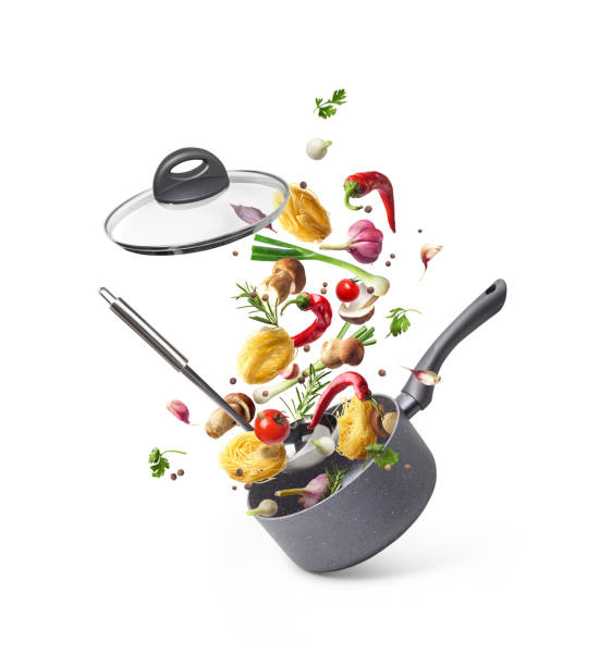 istock Composition with saucepans and pasta with vegetables flying in the air isolated on white background 1035539262