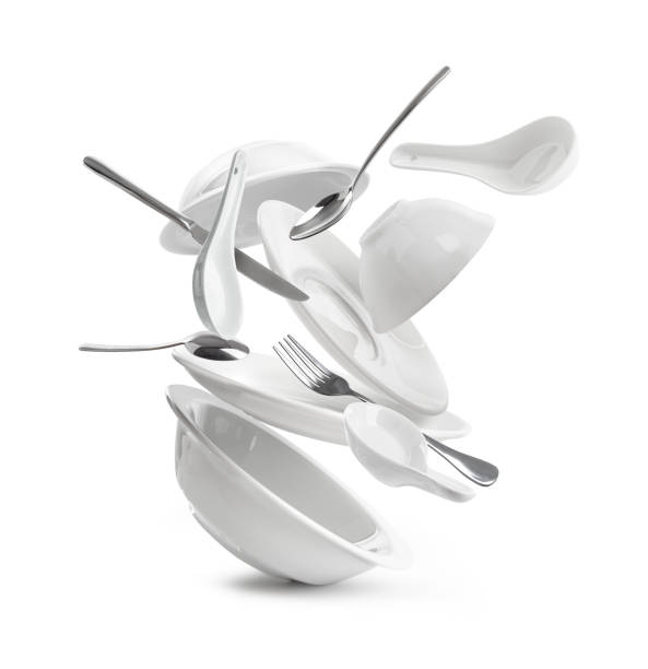 istock Falling dishes with cutlery on white background 1035539514