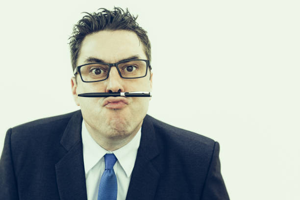 istock Crazy business expert holding pen on lips 1035541120