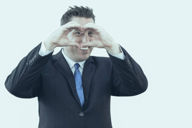 istock Cheerful businessman making heart with fingers 1035543406