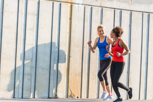 istock Two female athletes running together 1035544498