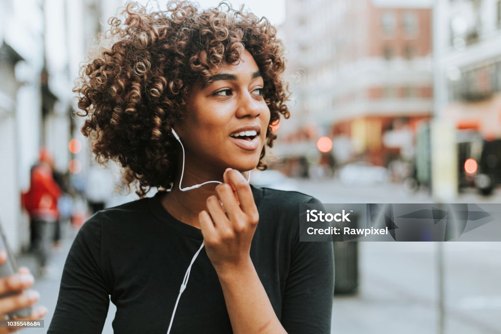 Cheerful woman talking through a headset Headphones Stock Photo