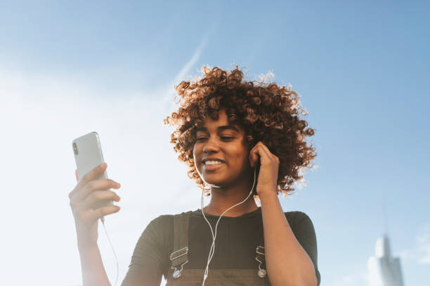 Girl listening to music from her phone stock photo