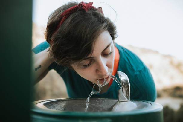 istock Woman drinking water from a water fountain 1035553954