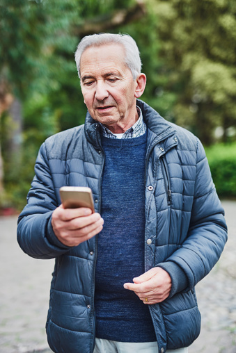 Shot of a senior man using a mobile phone in the park